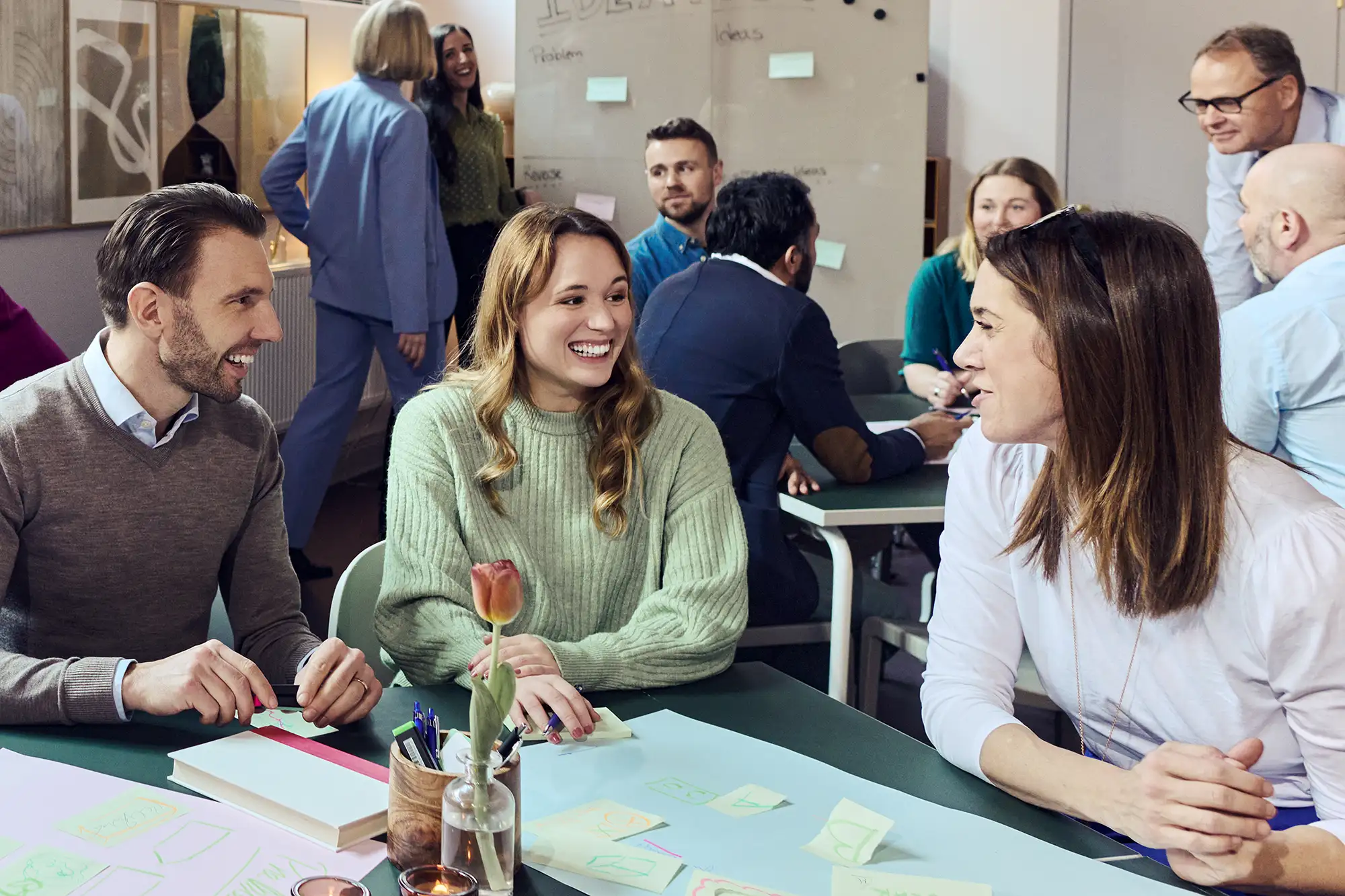 ett g&auml;ng glada medarbetare h&aring;ller workshop i ett trevligt rum